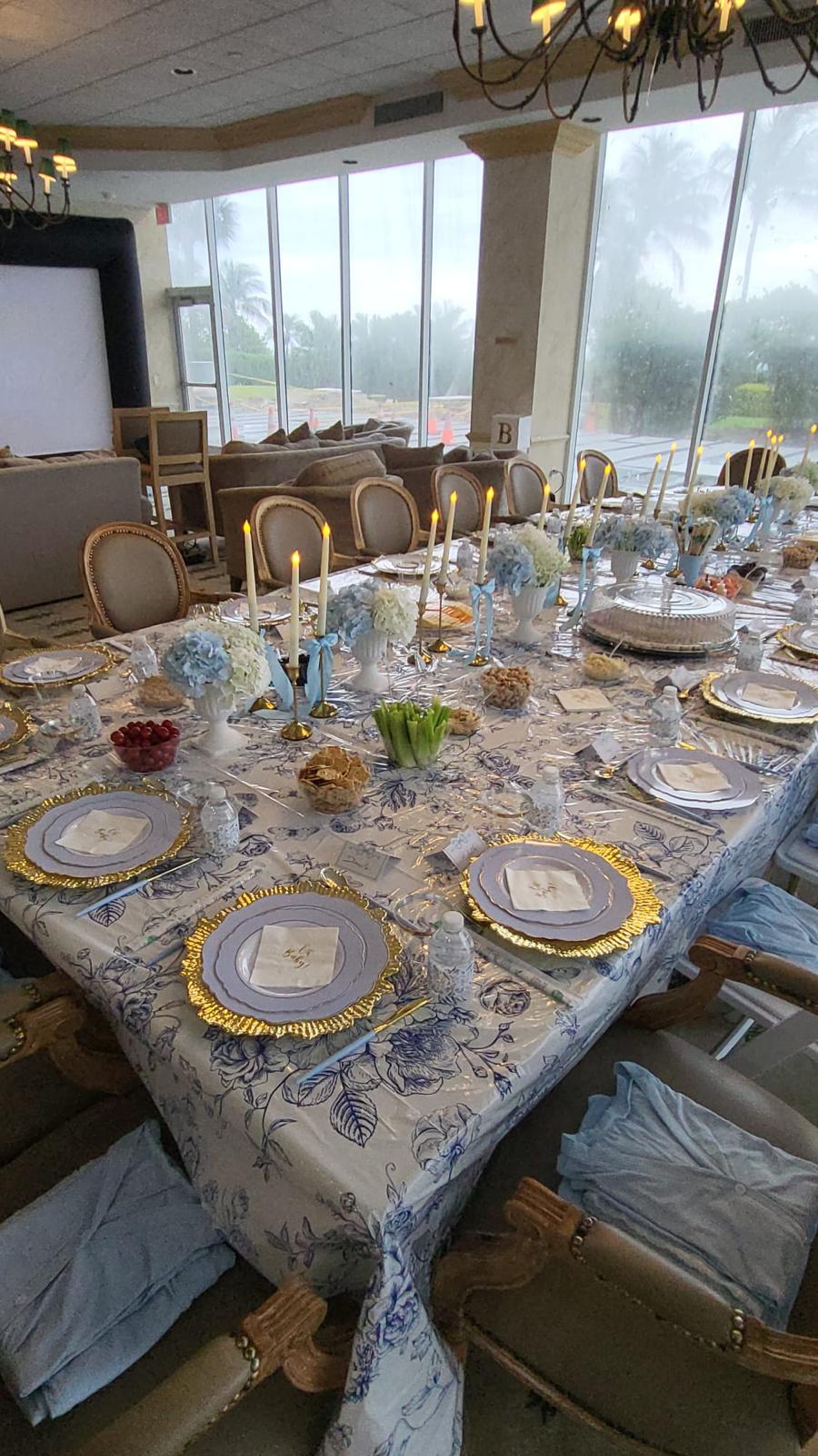 Private luxury dinner — blue toile linens, hydrangeas and lit taper candles